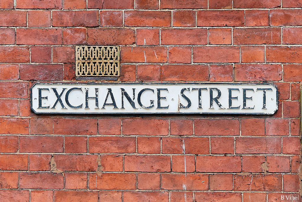 Exchange street sign on a red brick wall
