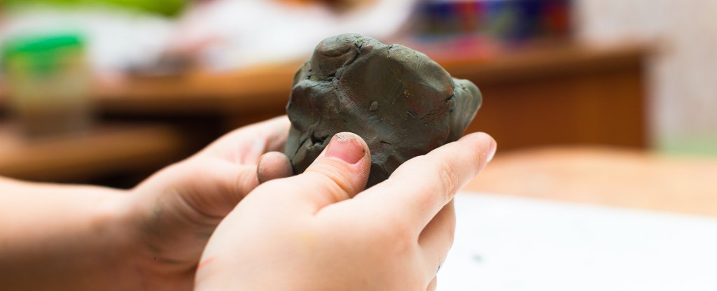 Image of a child's hands playing with clay