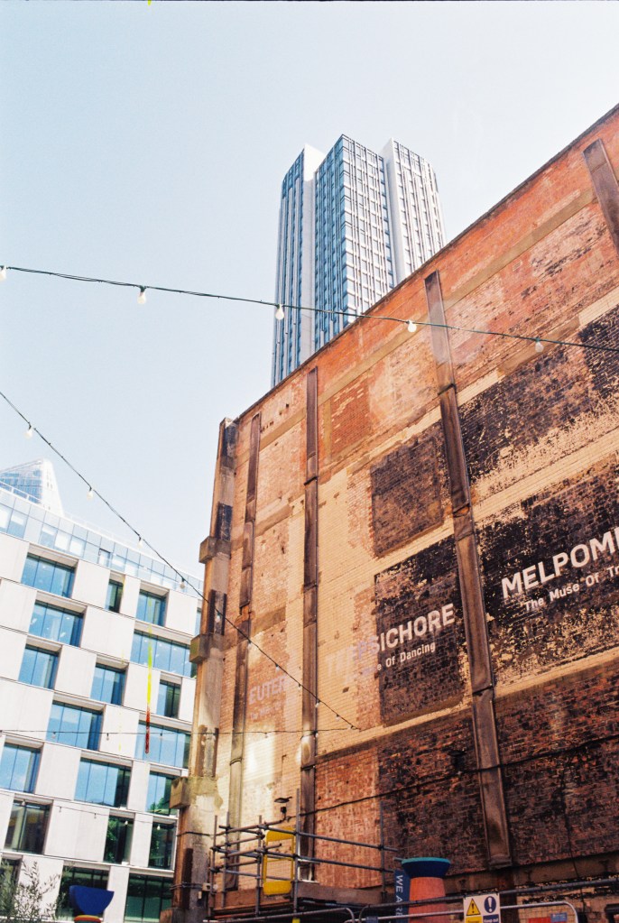 An old building behind the Oxo tower is contrasting with the nearby modern constructions