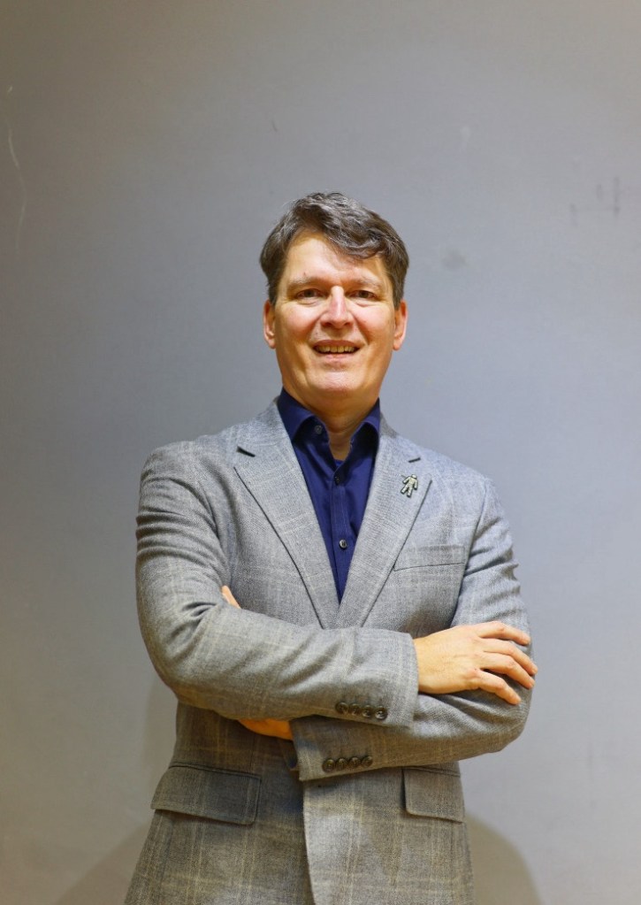 Bruno Vinel is looking at the camera with his arms crossed