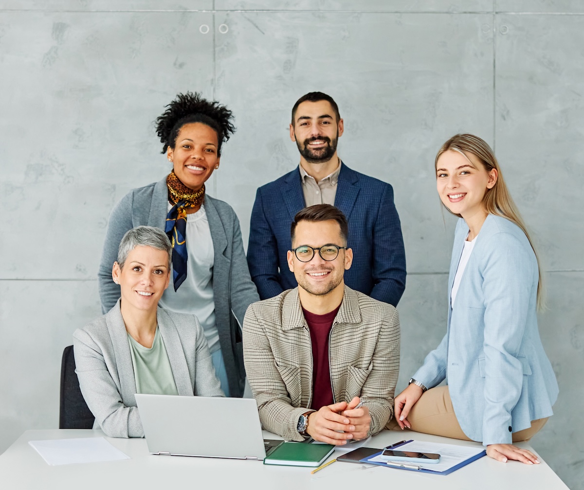 A diverse team of engaged colleagues collaborating around a table in a bright modern office
